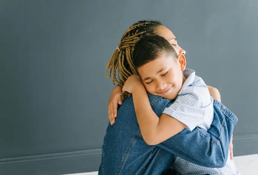Young child hugging a parental figure